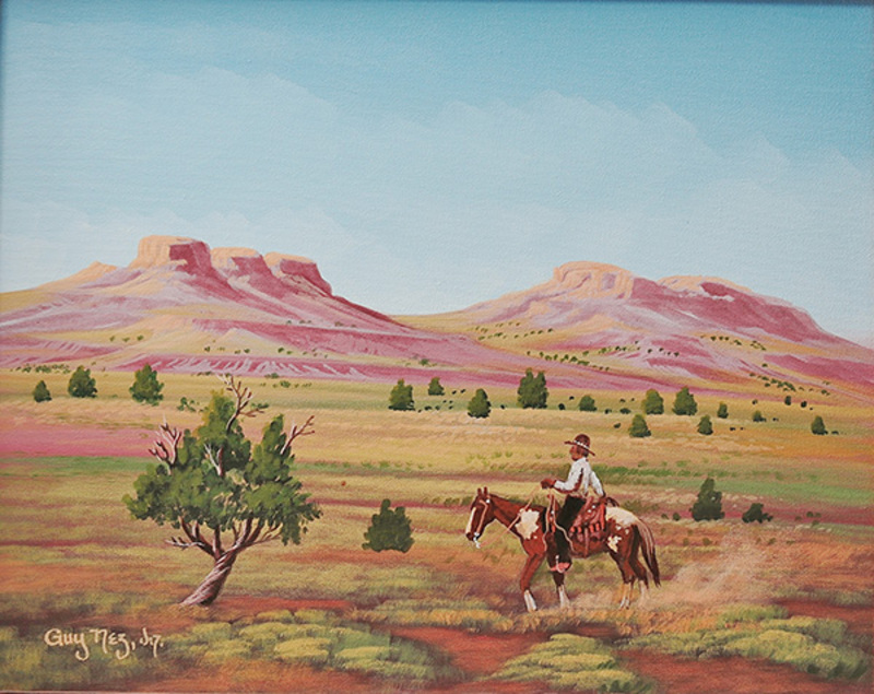 Navajo man riding across desert