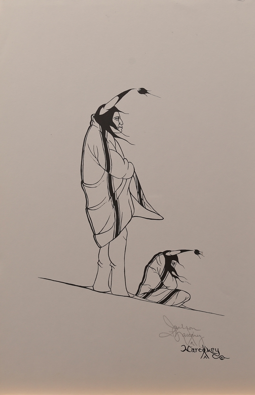 Standing and seated men in blankets